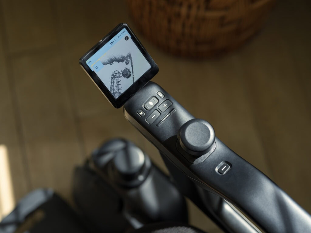 close up of a power wheelchair controller with a screen display.