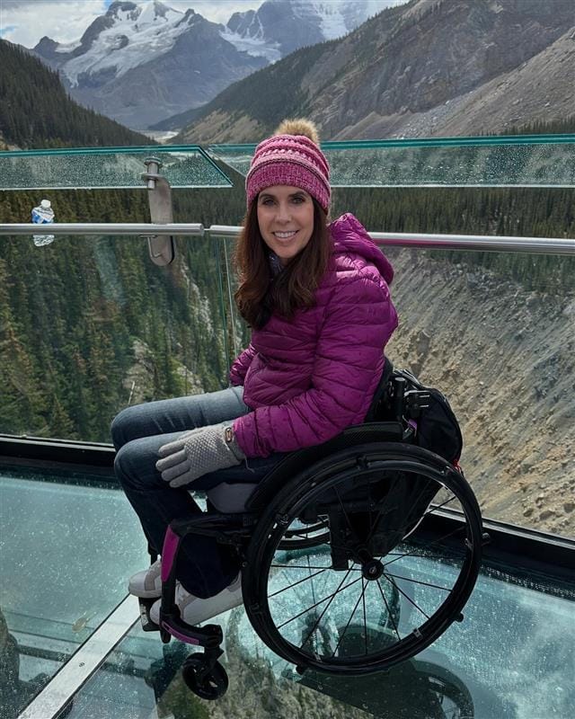 Accessible travel with wheelchairs overlooking scenic mountain landscape.