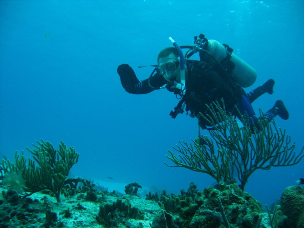 man underwater scuba diving