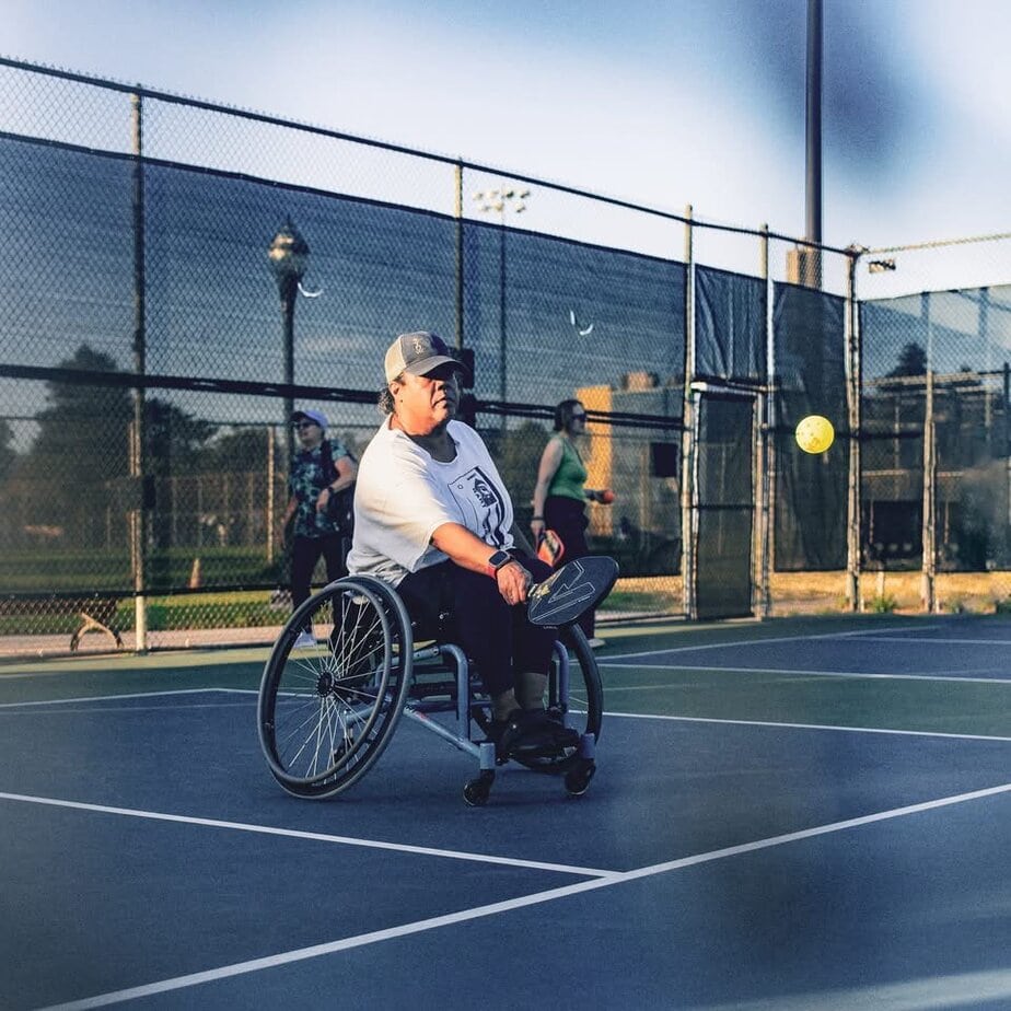 woman in wheelchair playing pickleball