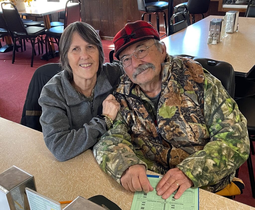 man and woman at a counter in a restaurant