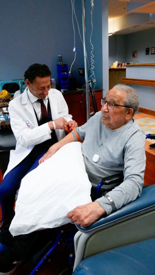 doctor interacting with a man using a wheelchair