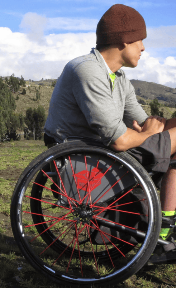 man using a manual wheelchair seen from side