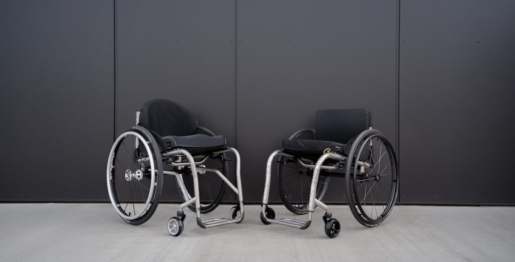 tilite wheelchairs shown against a black wall